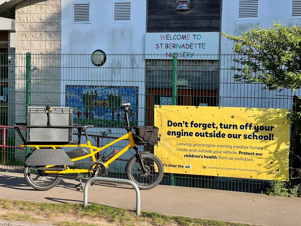 photo of the e-bike in front of a local school